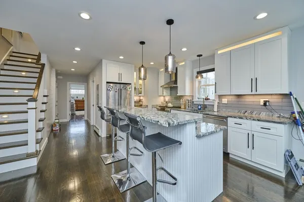 a kitchen with stainless steel appliances granite countertop a sink stove and cabinets