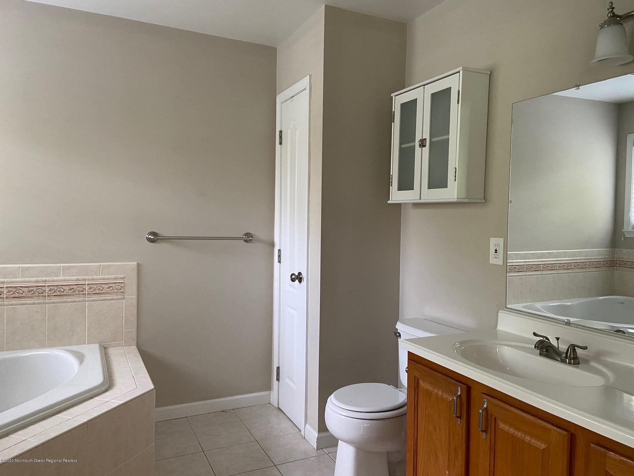 213 Topside Road Manahawkin, NJ 08050 - Photo 11 of 16 a bathroom with a sink toilet and shower