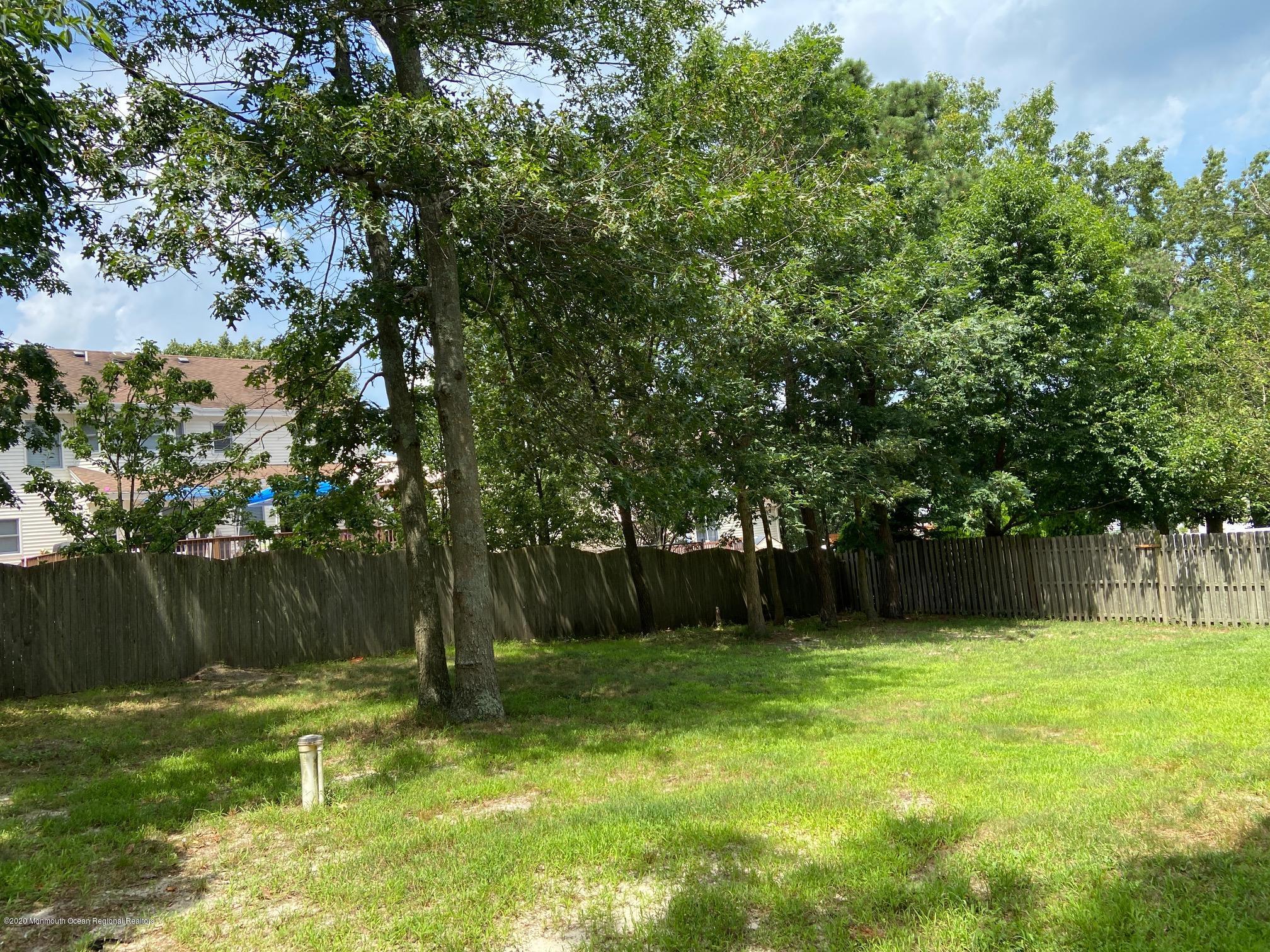 213 Topside Road Manahawkin, NJ 08050 - Photo 16 of 16 a view of a backyard with a slide