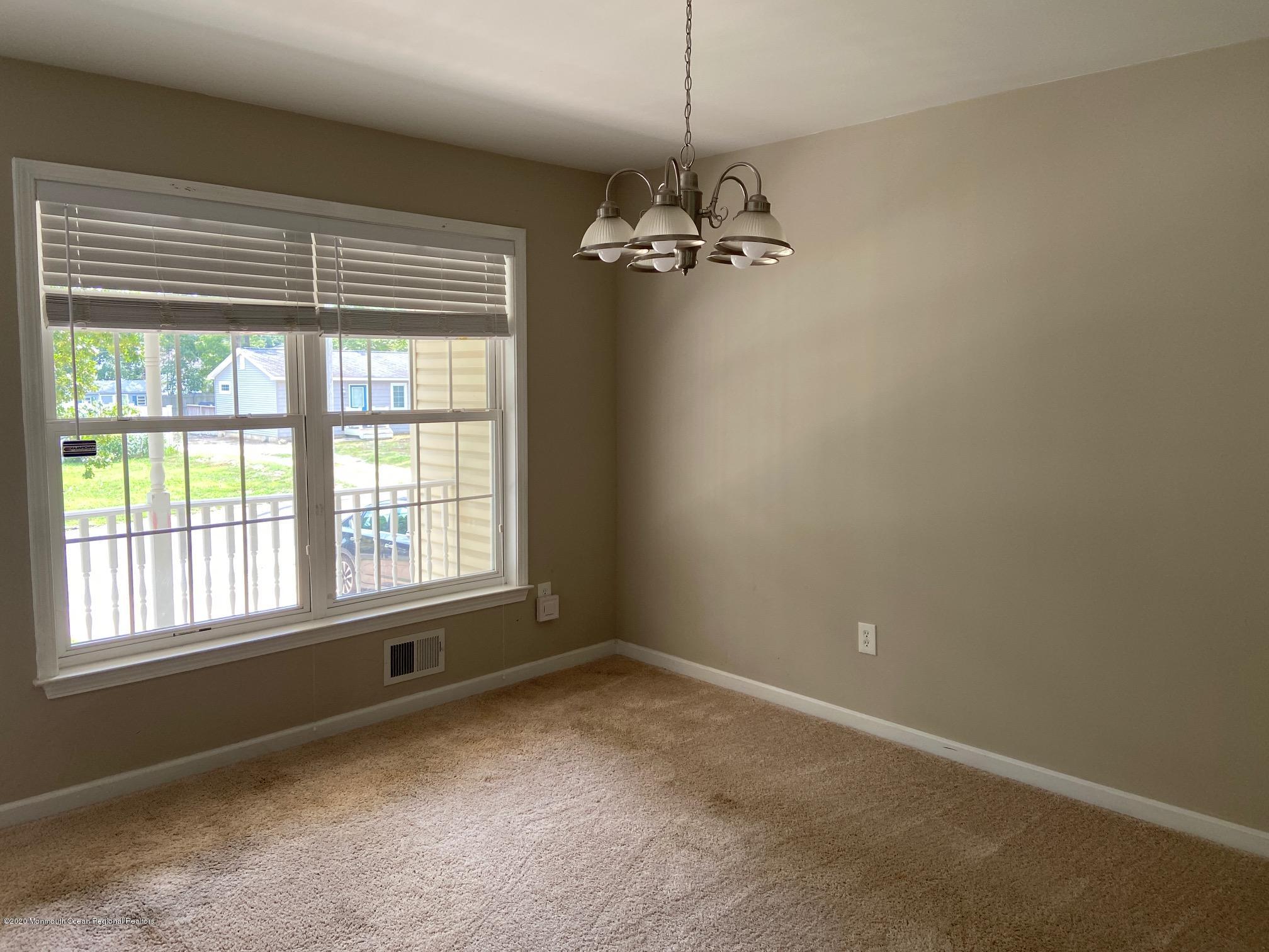 213 Topside Road Manahawkin, NJ 08050 - Photo 3 of 16 a view of a livingroom with a ceiling fan and window
