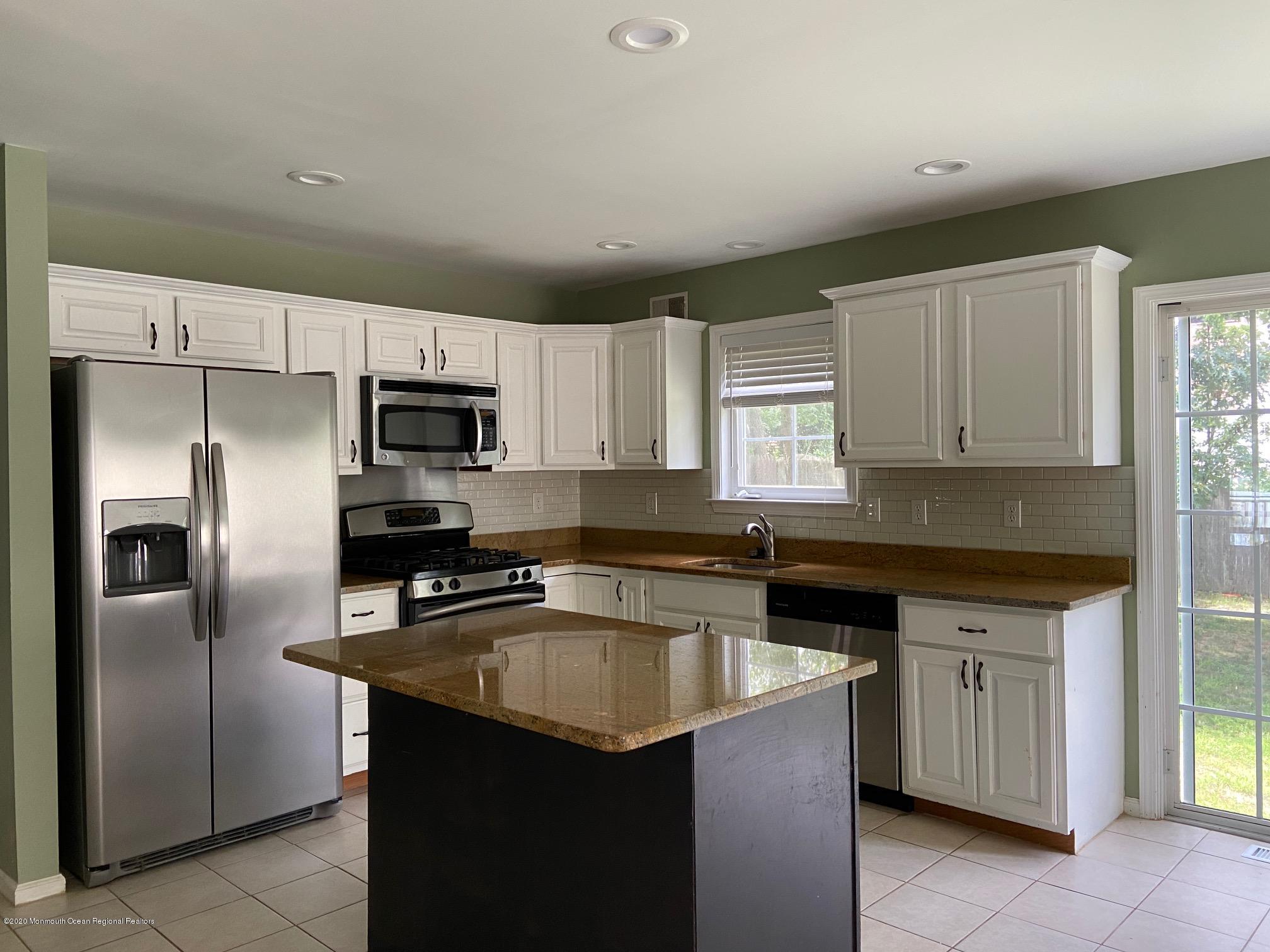 213 Topside Road Manahawkin, NJ 08050 - Photo 4 of 16 a kitchen with a sink stove and refrigerator