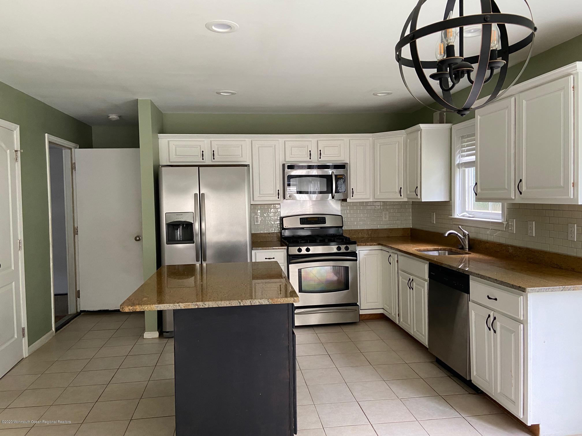 213 Topside Road Manahawkin, NJ 08050 - Photo 5 of 16 a kitchen with stainless steel appliances a refrigerator sink and cabinets