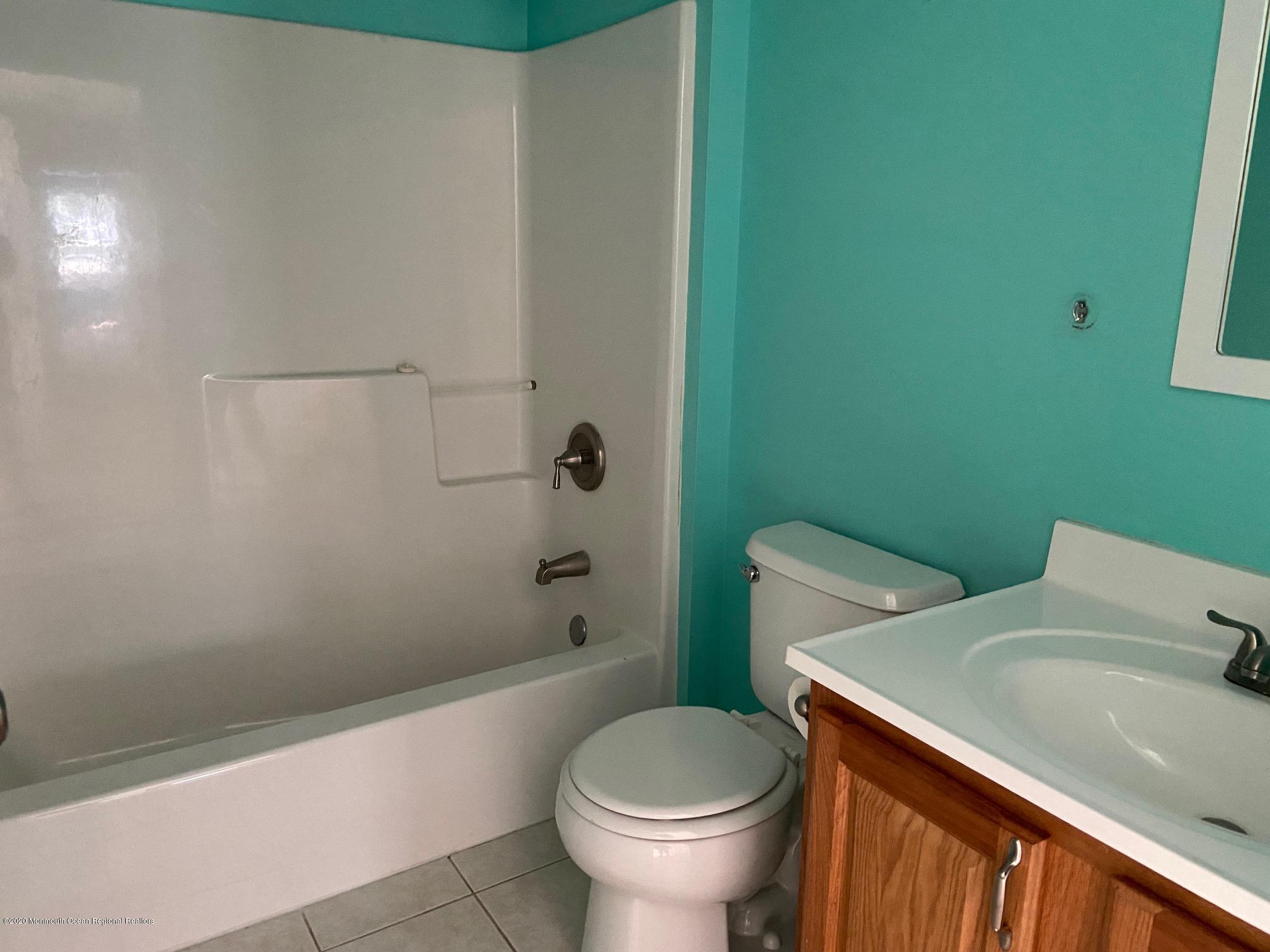 213 Topside Road Manahawkin, NJ 08050 - Photo 9 of 16 a bathroom with a sink a toilet and shower