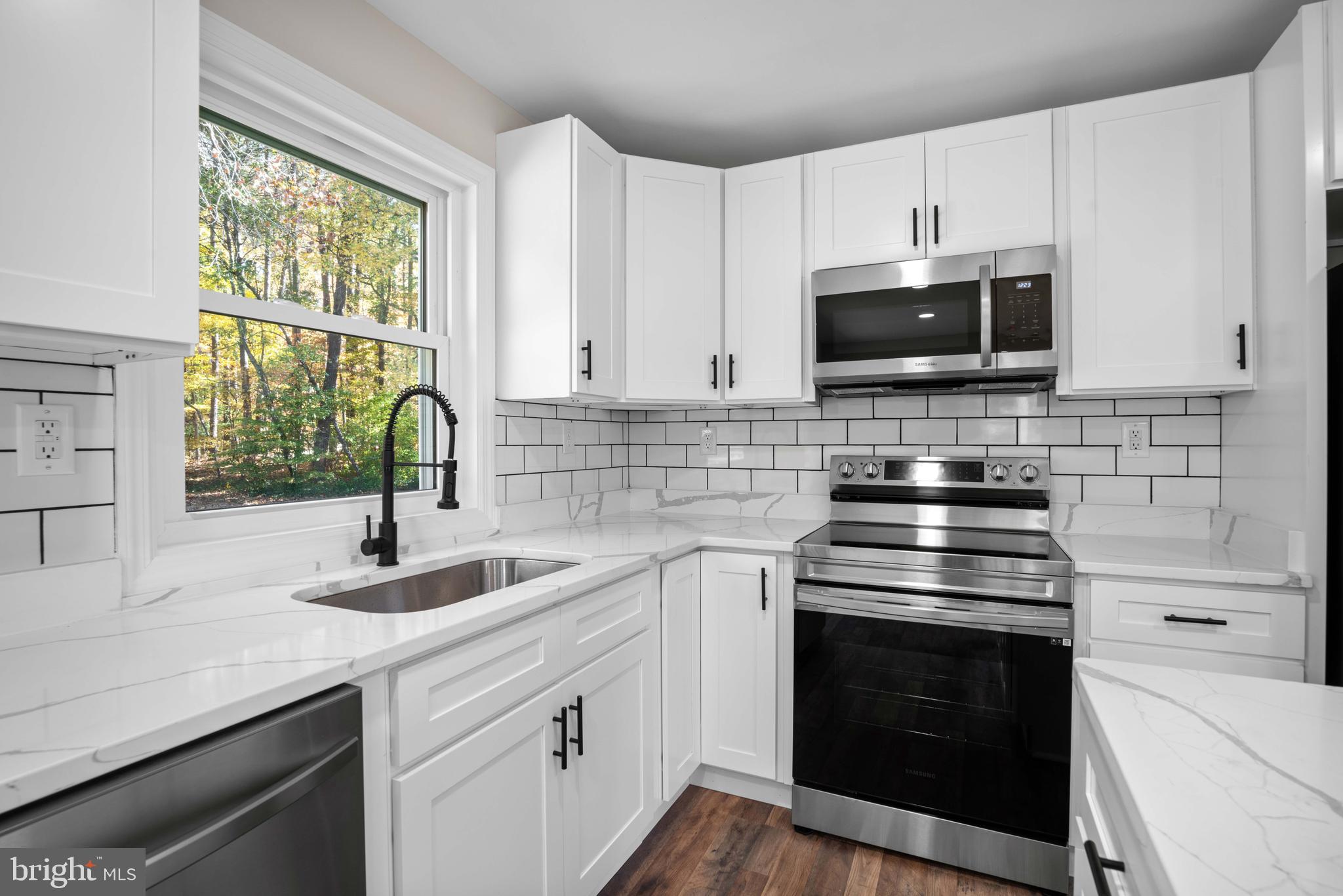 15388 Point Lookout Road St. Inigoes, MD 20684 - Photo 8 of 29 a kitchen with appliances a sink and a window