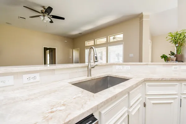 a kitchen with cabinets and wooden floor
