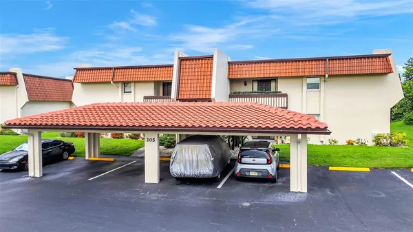 a front view of a house with a garden and parking space
