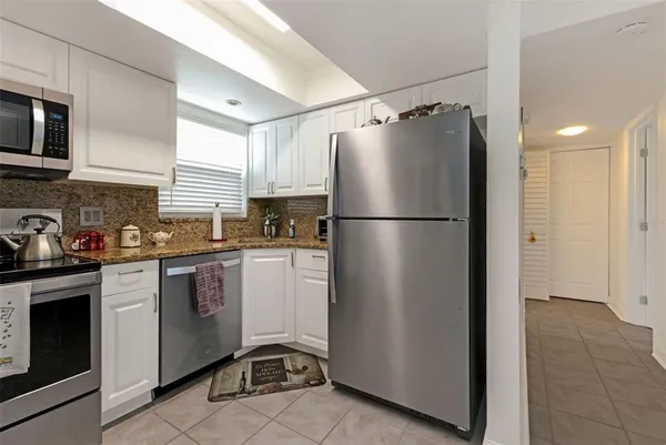 a white refrigerator freezer sitting inside of a kitchen