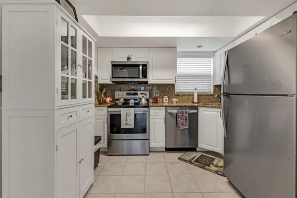 a kitchen with stainless steel appliances a refrigerator sink and stove