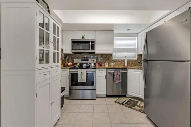 a kitchen with stainless steel appliances a refrigerator sink and stove
