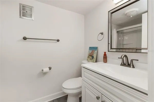 a bathroom with a sink a toilet and mirror