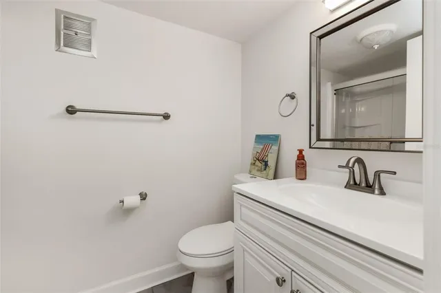 a bathroom with a sink a toilet and mirror