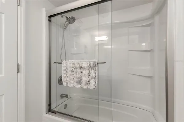 a bathroom with a glass shower door