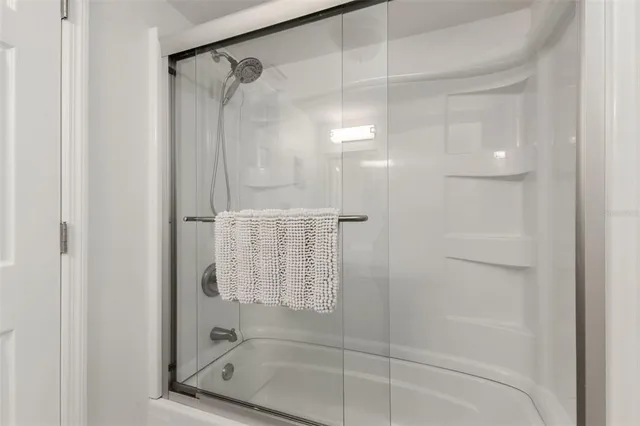 a bathroom with a glass shower door