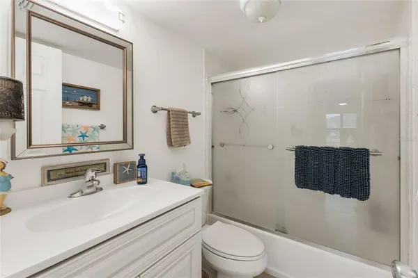 a bathroom with a sink vanity granite and a mirror