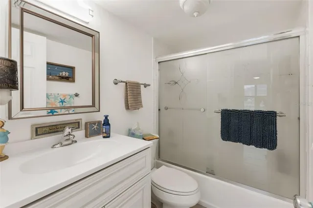 a bathroom with a sink vanity granite and a mirror