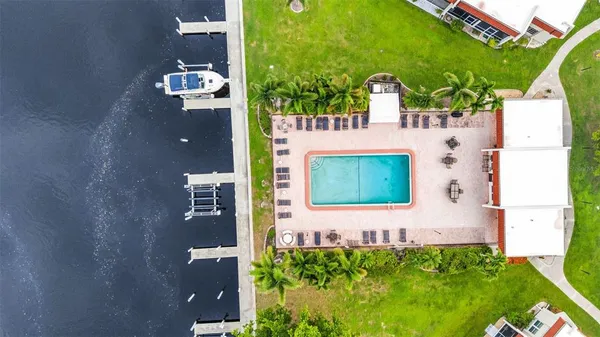 an aerial view of a house with a swimming pool yard and outdoor seating