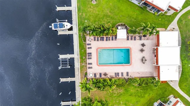 an aerial view of a house with a swimming pool yard and outdoor seating