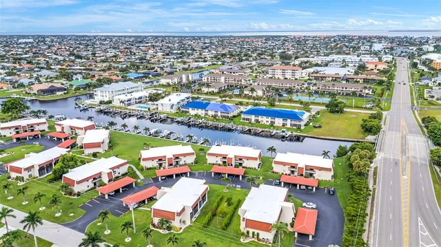 an aerial view of a house with a garden and lake view