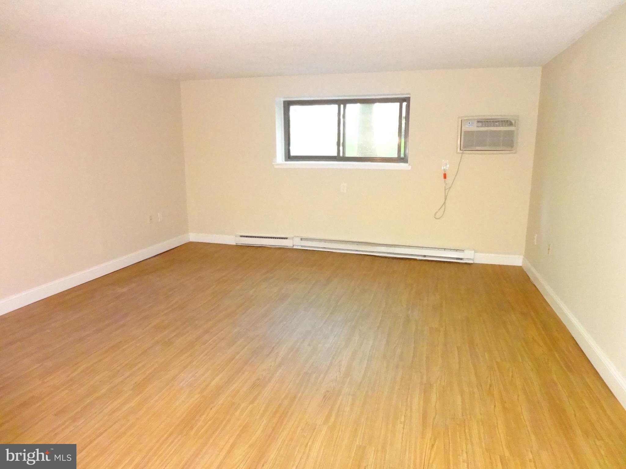 400 Glendale Road Havertown, PA 19083 - Photo 15 of 24 an empty room with wooden floor and windows