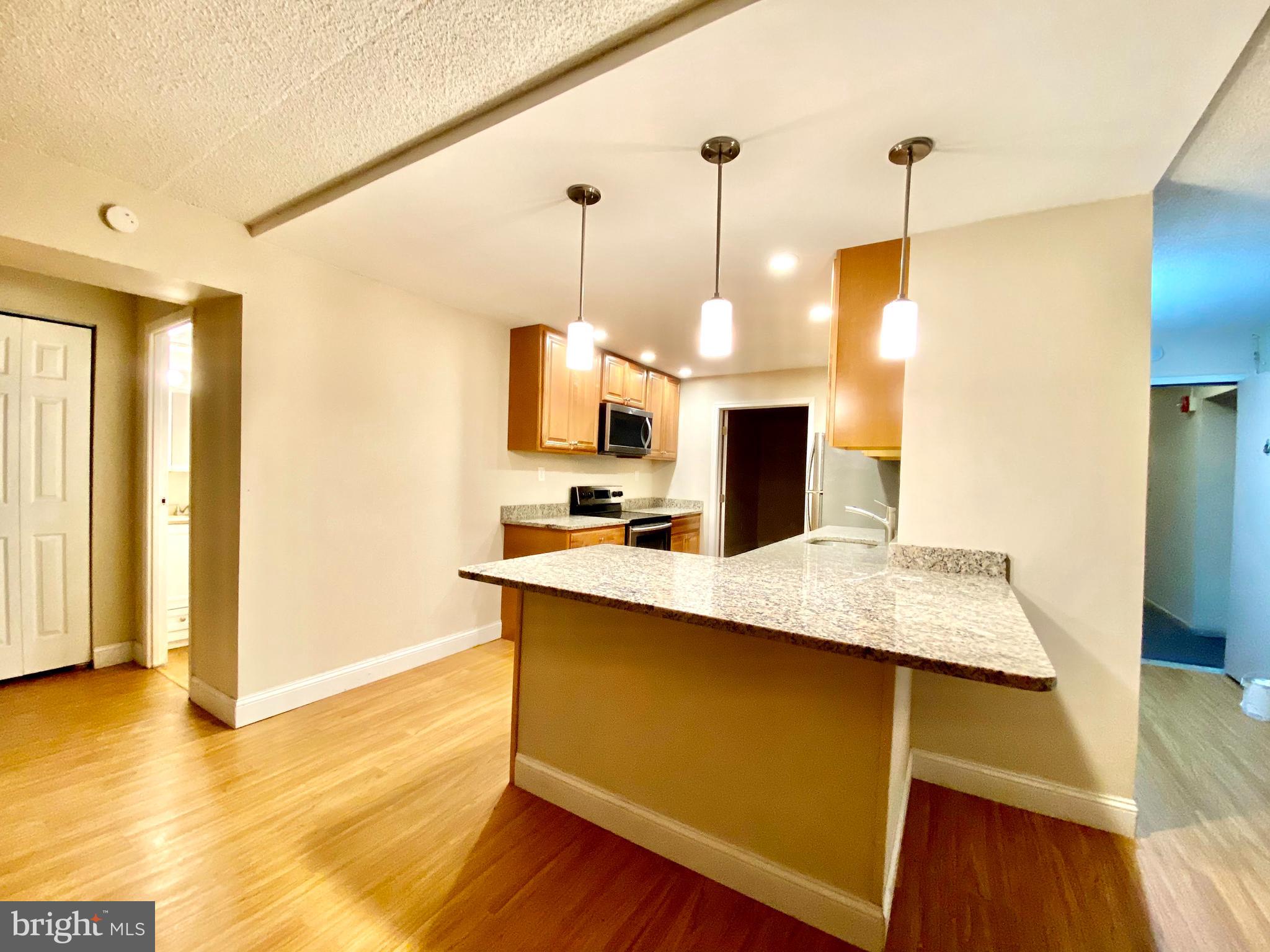 400 Glendale Road Havertown, PA 19083 - Photo 19 of 24 a kitchen with kitchen island a sink appliances and wooden floor