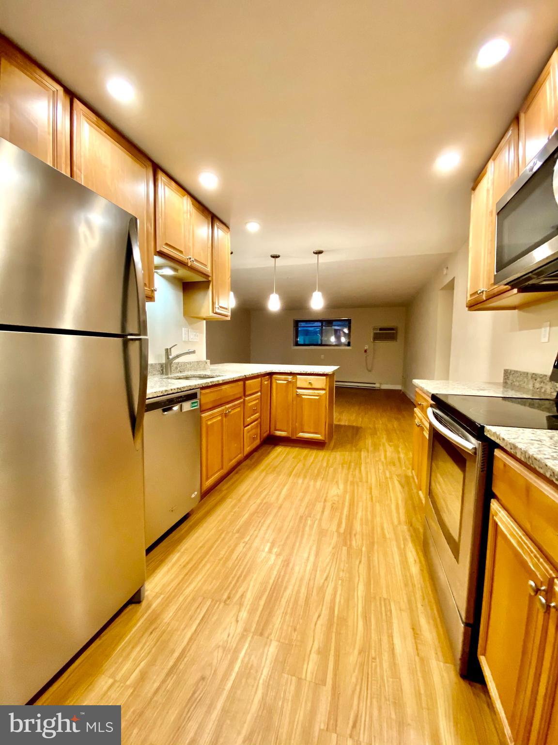 400 Glendale Road Havertown, PA 19083 - Photo 23 of 24 a view of a kitchen with a sink and a refrigerator