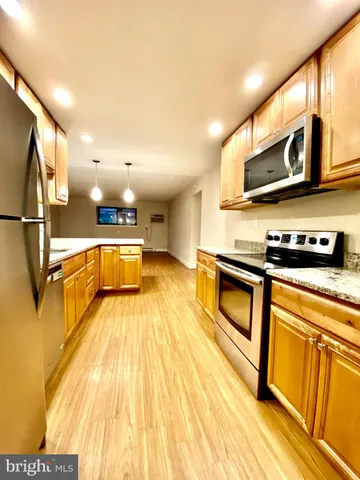 a kitchen with stainless steel appliances granite countertop a sink a stove and cabinets