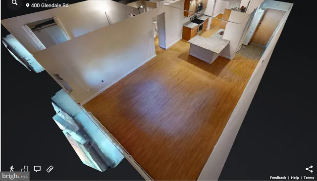 a view of kitchen with stainless steel appliances wooden floor and living room