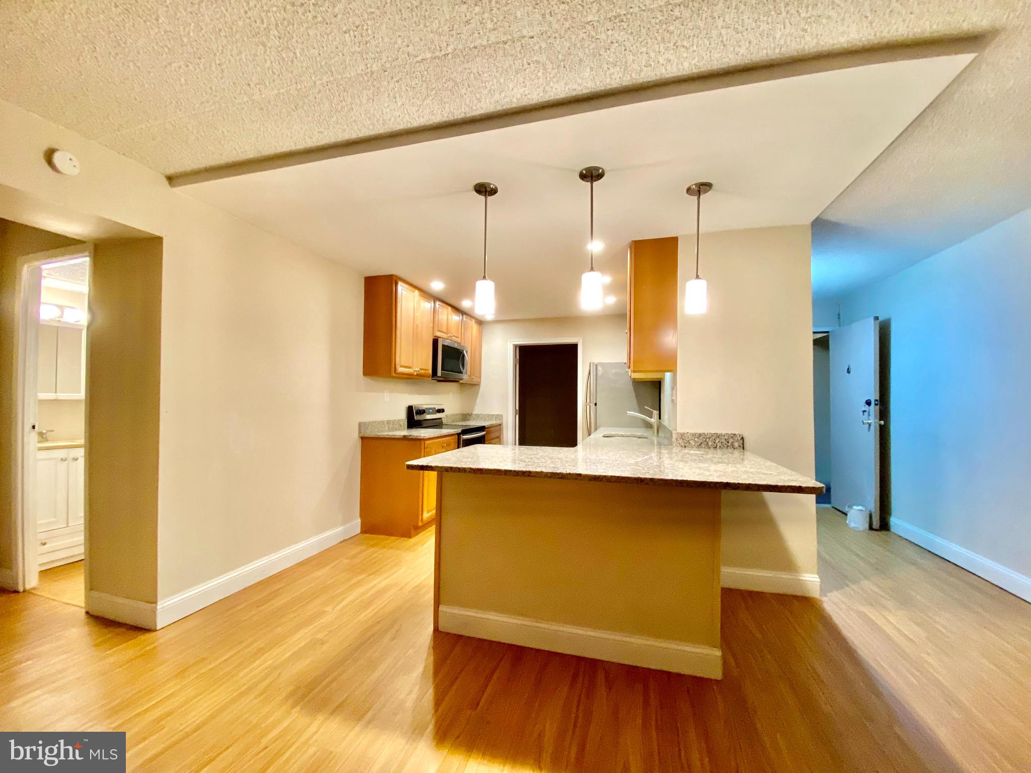 400 Glendale Road Havertown, PA 19083 - Photo 9 of 24 a view of kitchen with stainless steel appliances wooden floor and living room