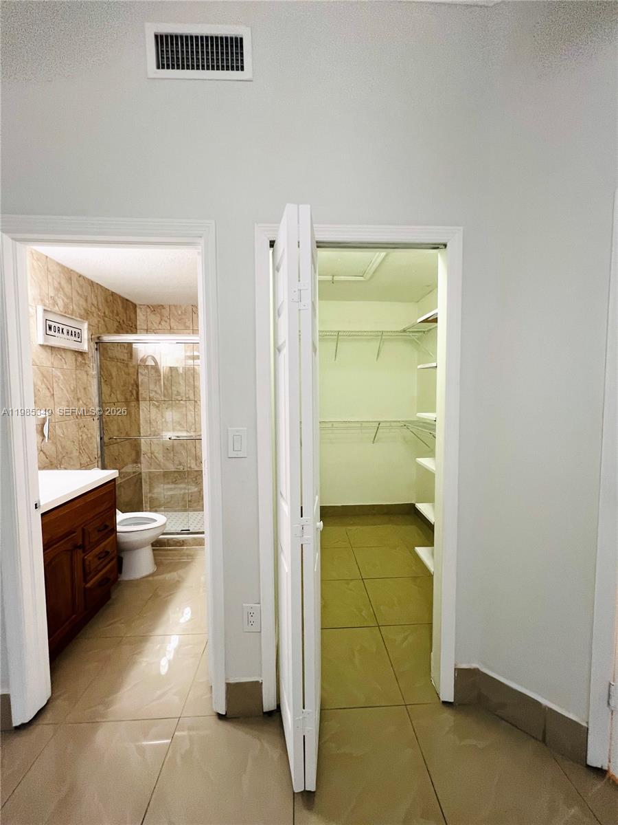 3380 Northeast 9th Street, Unit 203 Homestead, FL 33033 - Photo 11 of 21 a bathroom with a toilet and a shower