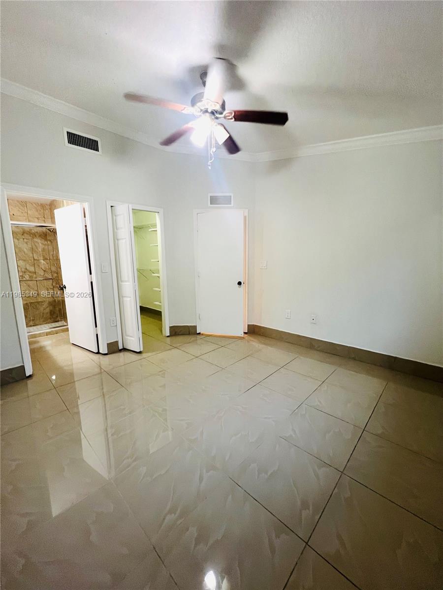 3380 Northeast 9th Street, Unit 203 Homestead, FL 33033 - Photo 14 of 21 en empty room with windows and fan