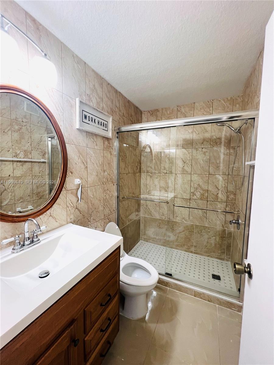 3380 Northeast 9th Street, Unit 203 Homestead, FL 33033 - Photo 15 of 21 a bathroom with a sink toilet and shower