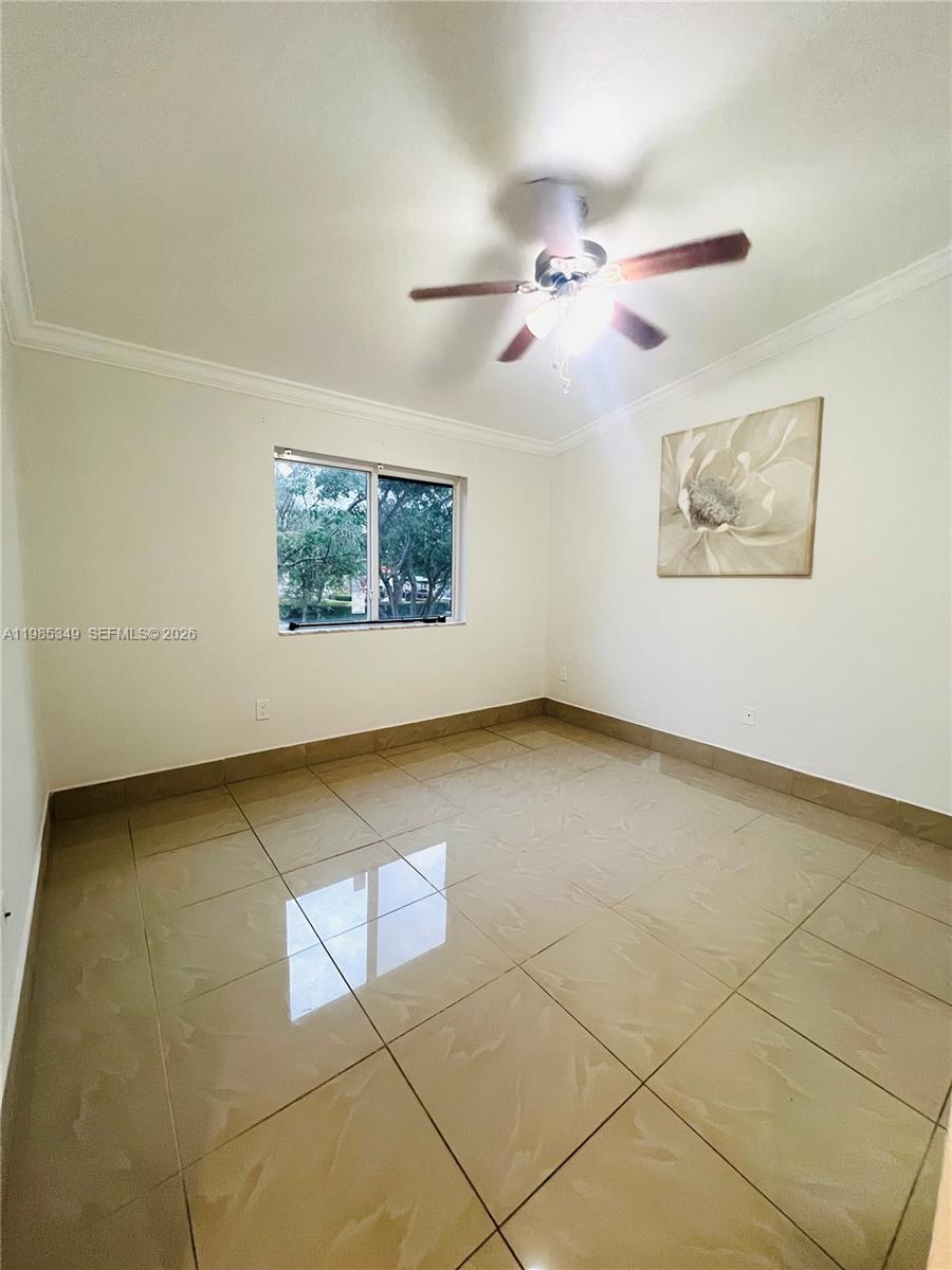 3380 Northeast 9th Street, Unit 203 Homestead, FL 33033 - Photo 16 of 21 an empty room with a ceiling fan and window
