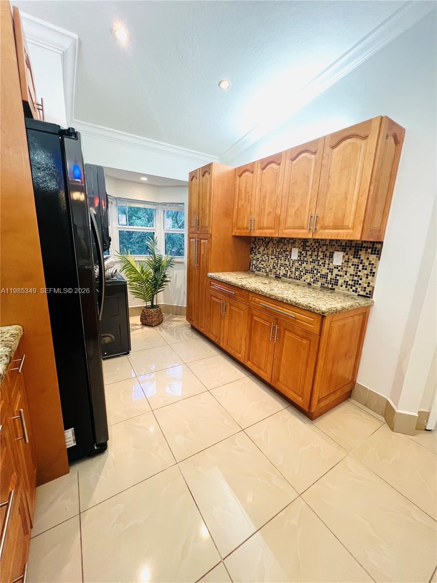 3380 Northeast 9th Street, Unit 203 Homestead, FL 33033 - Photo 18 of 21 a kitchen with stainless steel appliances a refrigerator sink and microwave