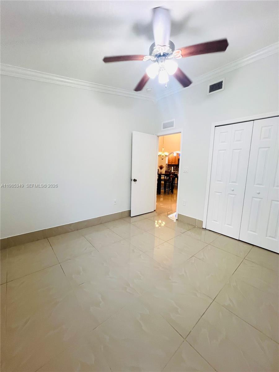 3380 Northeast 9th Street, Unit 203 Homestead, FL 33033 - Photo 21 of 21 an empty room with chandelier fan and windows