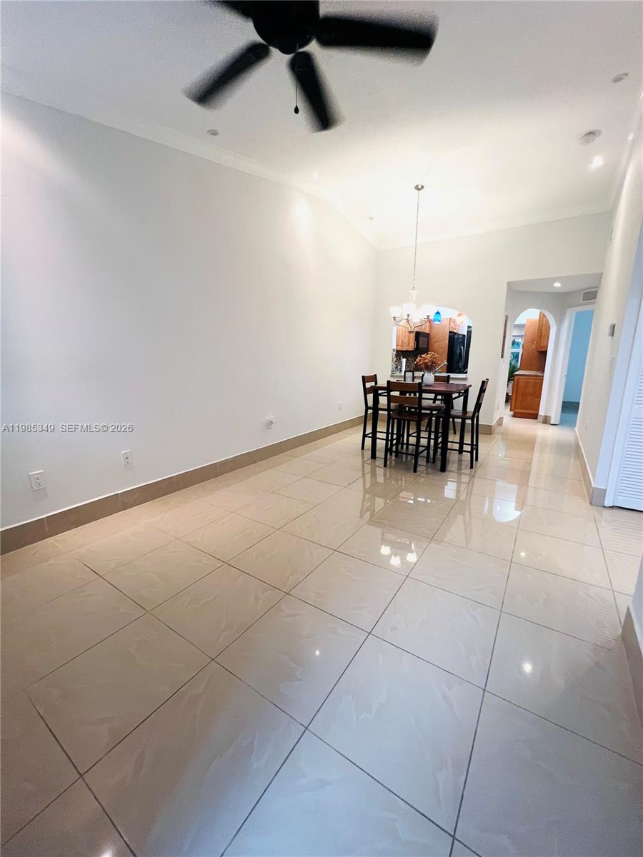 3380 Northeast 9th Street, Unit 203 Homestead, FL 33033 - Photo 8 of 21 a view of a dining room with furniture and chandelier