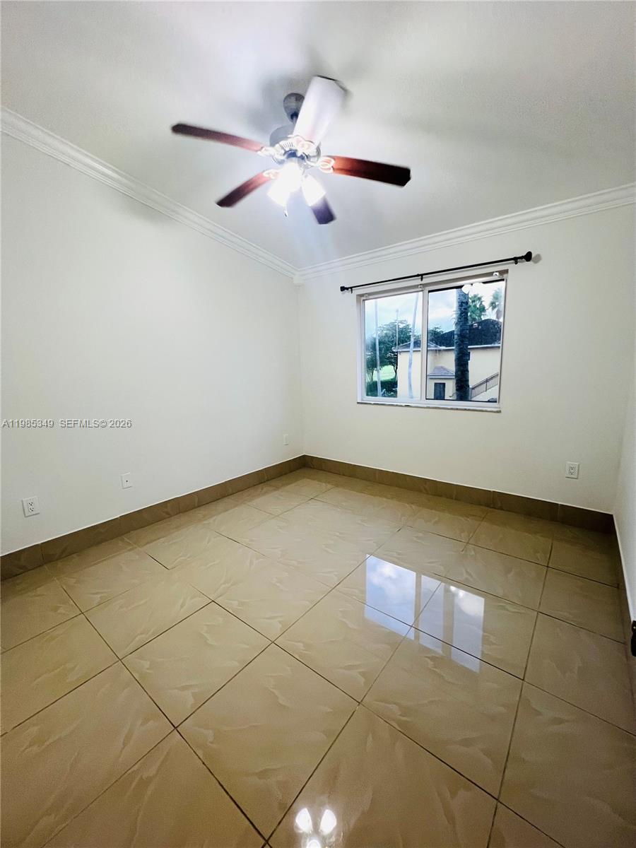 3380 Northeast 9th Street, Unit 203 Homestead, FL 33033 - Photo 10 of 21 an empty room with windows and ceiling fan
