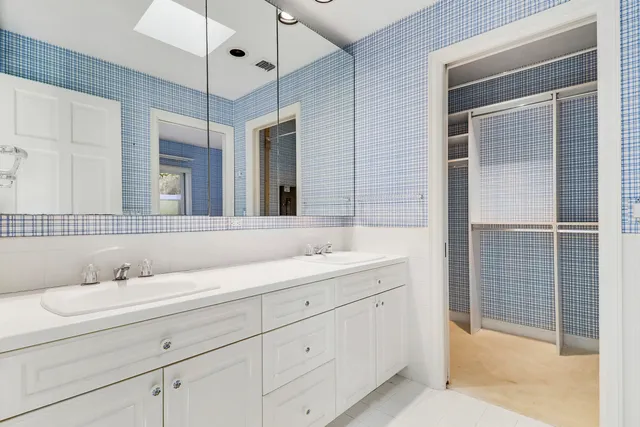 a bathroom with a double vanity sink and mirror
