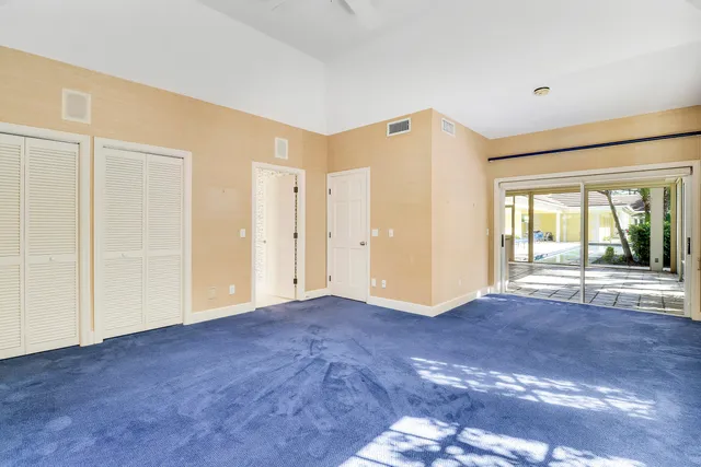 a view of an empty room with glass door