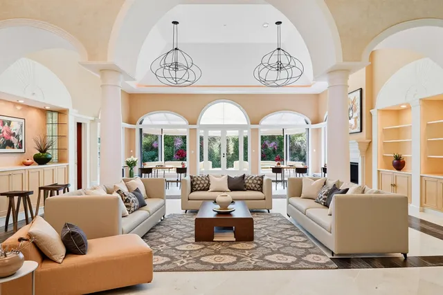 a living room with furniture fireplace and a large window