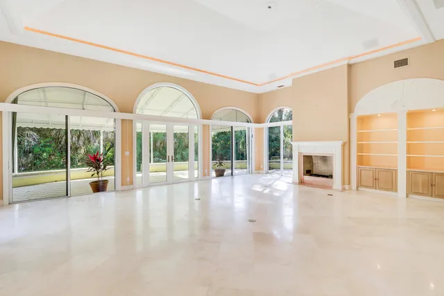 a view of empty room with large windows