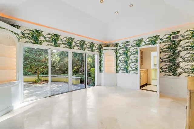 a view of an empty room with a sliding door and balcony