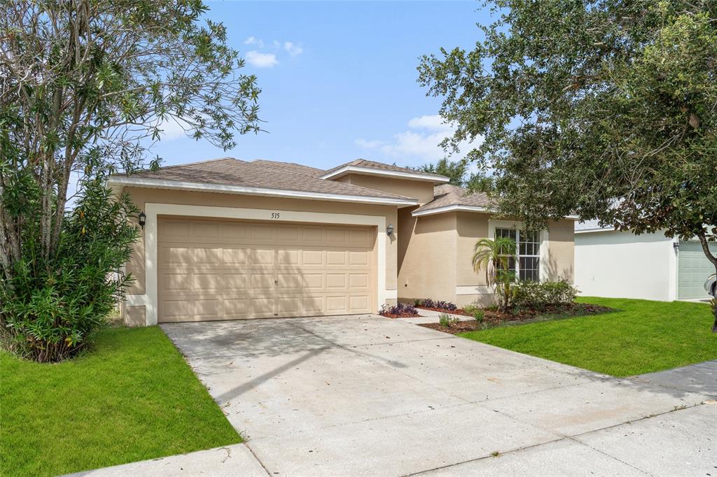 515 Ronshelle Avenue Haines City, FL 33844 - Photo 1 of 1 a front view of a house with a garden and yard