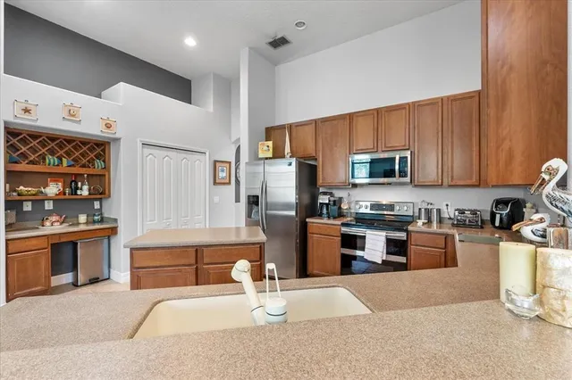 a kitchen with sink refrigerator and window