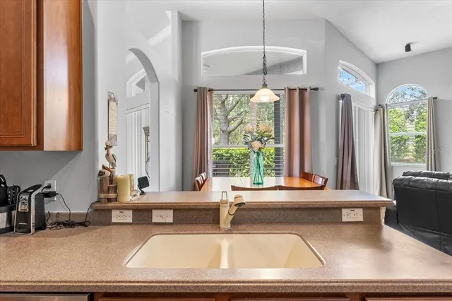 a kitchen with stainless steel appliances granite countertop a refrigerator a sink and a stove