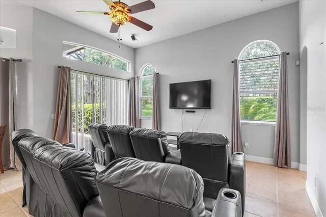 a spacious bedroom with a bed and a flat screen tv