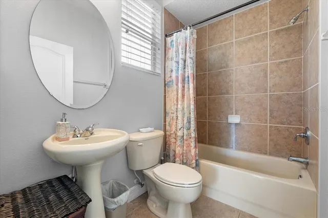 a bedroom with two beds and a flat screen tv