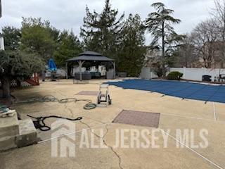 48 Eastern Drive Kendall Park, NJ 08824 - Photo 4 of 9 a view of a swimming pool with a patio