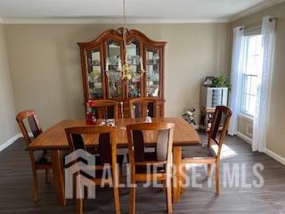 48 Eastern Drive Kendall Park, NJ 08824 - Photo 5 of 9 a view of a dining room with furniture window and wooden floor