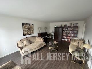 48 Eastern Drive Kendall Park, NJ 08824 - Photo 6 of 9 a living room with furniture a rug and a wall painting