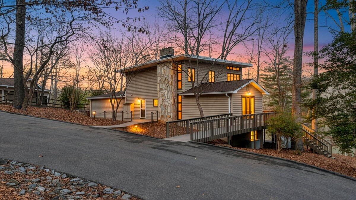 2768 Lake Retreat Road Huddleston, VA 24104 - Photo 2 of 92 a front view of a house with garage and trees